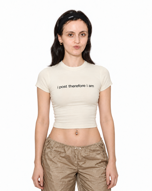 Model wearing I Post Therefore I Am cream baby tee, front view